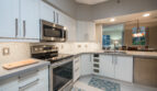 Modern kitchen appliances, featuring a dishwasher and stove, at Village By The Bay, Aventura, Florida