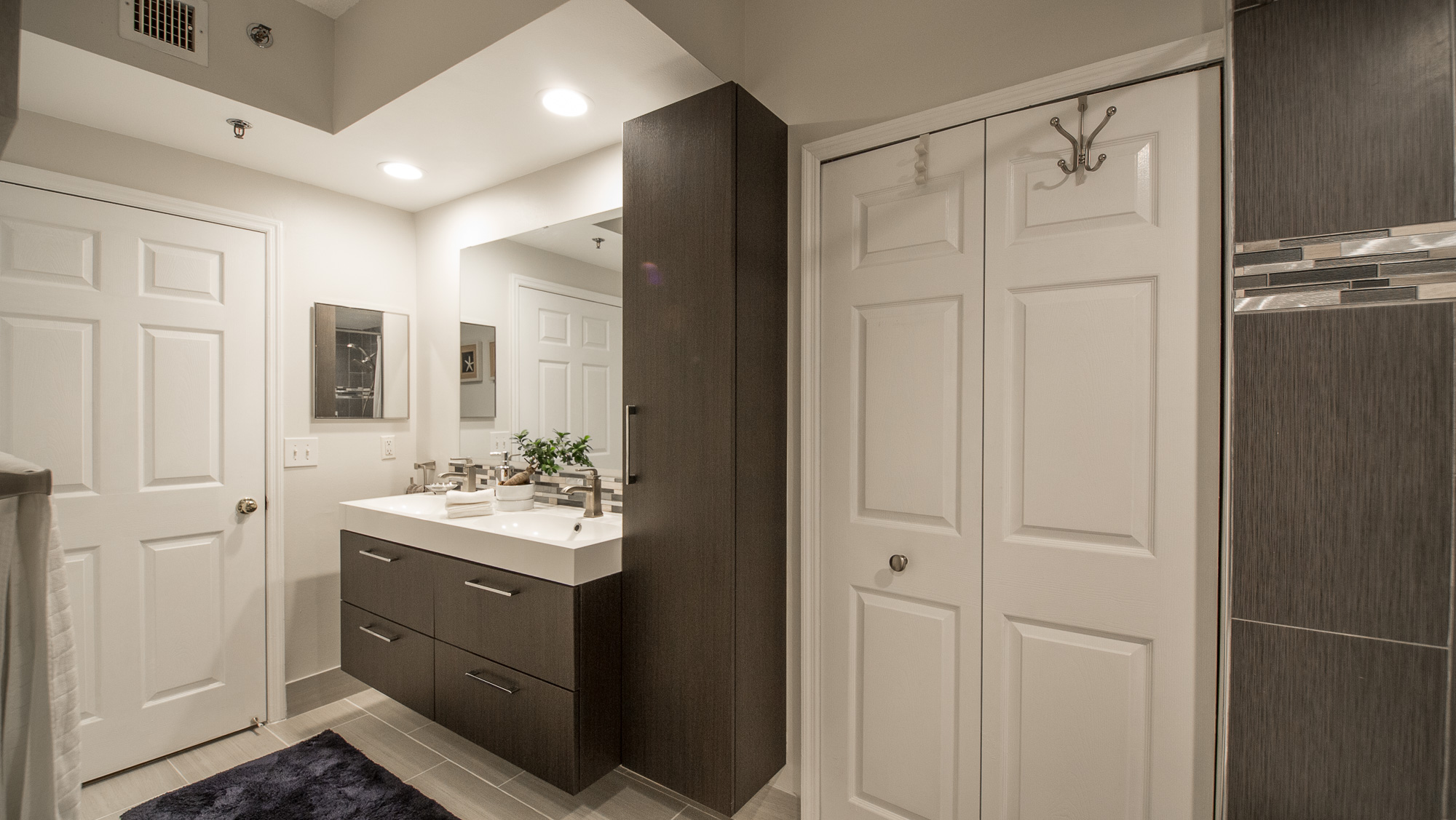 View of the bathroom, entrance, and walk-in closet in a one-bedroom apartment at Village By The Bay, Aventu...