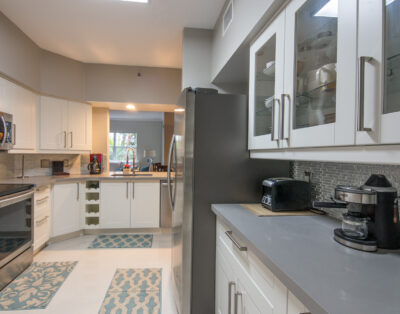 Well-equipped kitchen in a one-bedroom apartment with modern appliances at Village By The Bay, Aventura, Florida