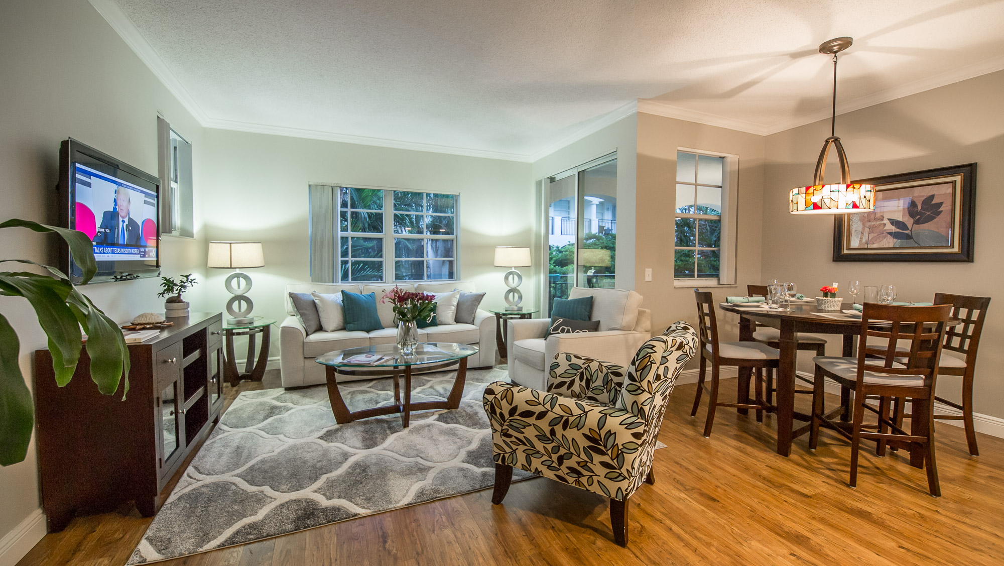 Spacious living room with a TV and dining table in a one-bedroom apartment at Village By The Bay, Aventura,...