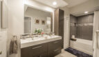 View of bathroom sinks and bathtub in a one-bedroom apartment at Village By The Bay, Aventura, Florida