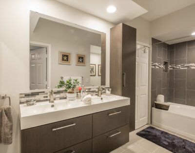 View of bathroom sinks and bathtub in a one-bedroom apartment at Village By The Bay, Aventura, Florida