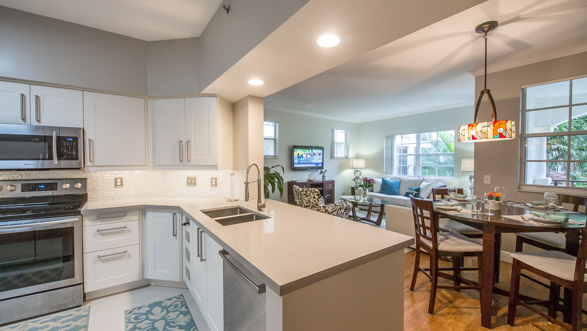 View from the kitchen countertop to the dining table in a one-bedroom apartment at Village By The Bay, Aven...