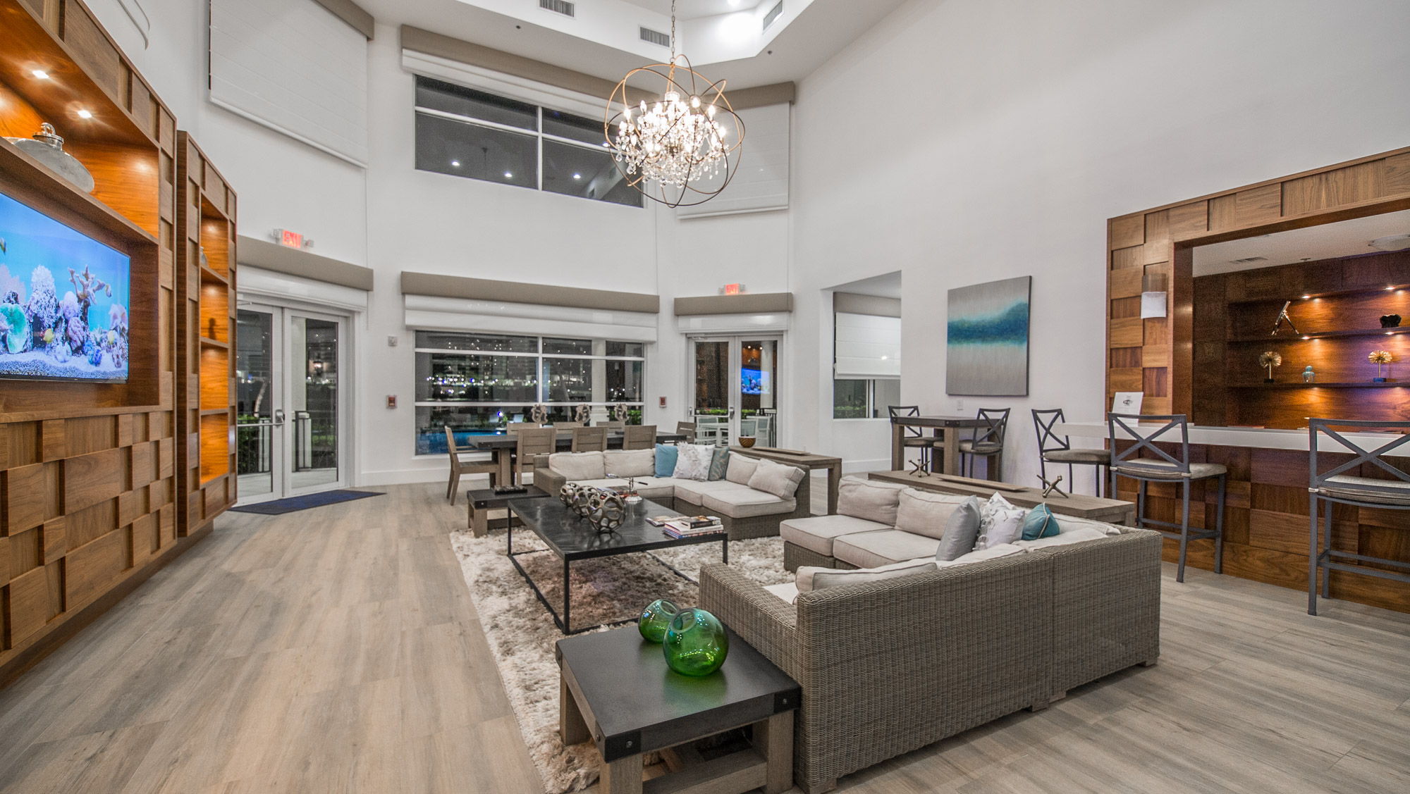 Nighttime view of the illuminated Club House at Village By The Bay