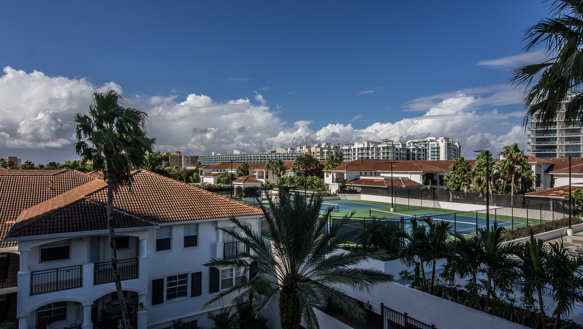 View of the tennis court and surrounding buildings at Village By The Bay, Aventura, Florida