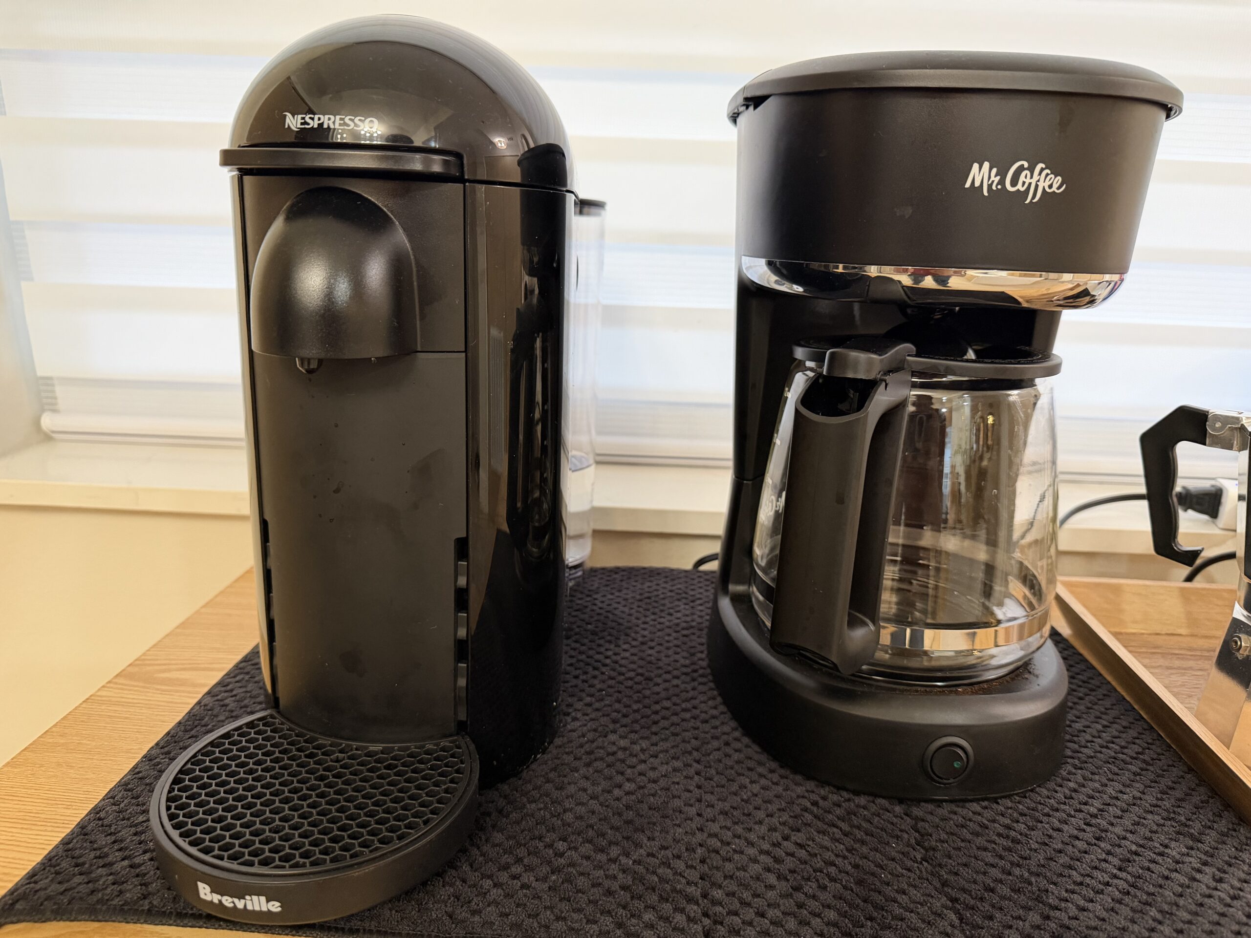 Coffee station with espresso machine and supplies on the kitchen counter