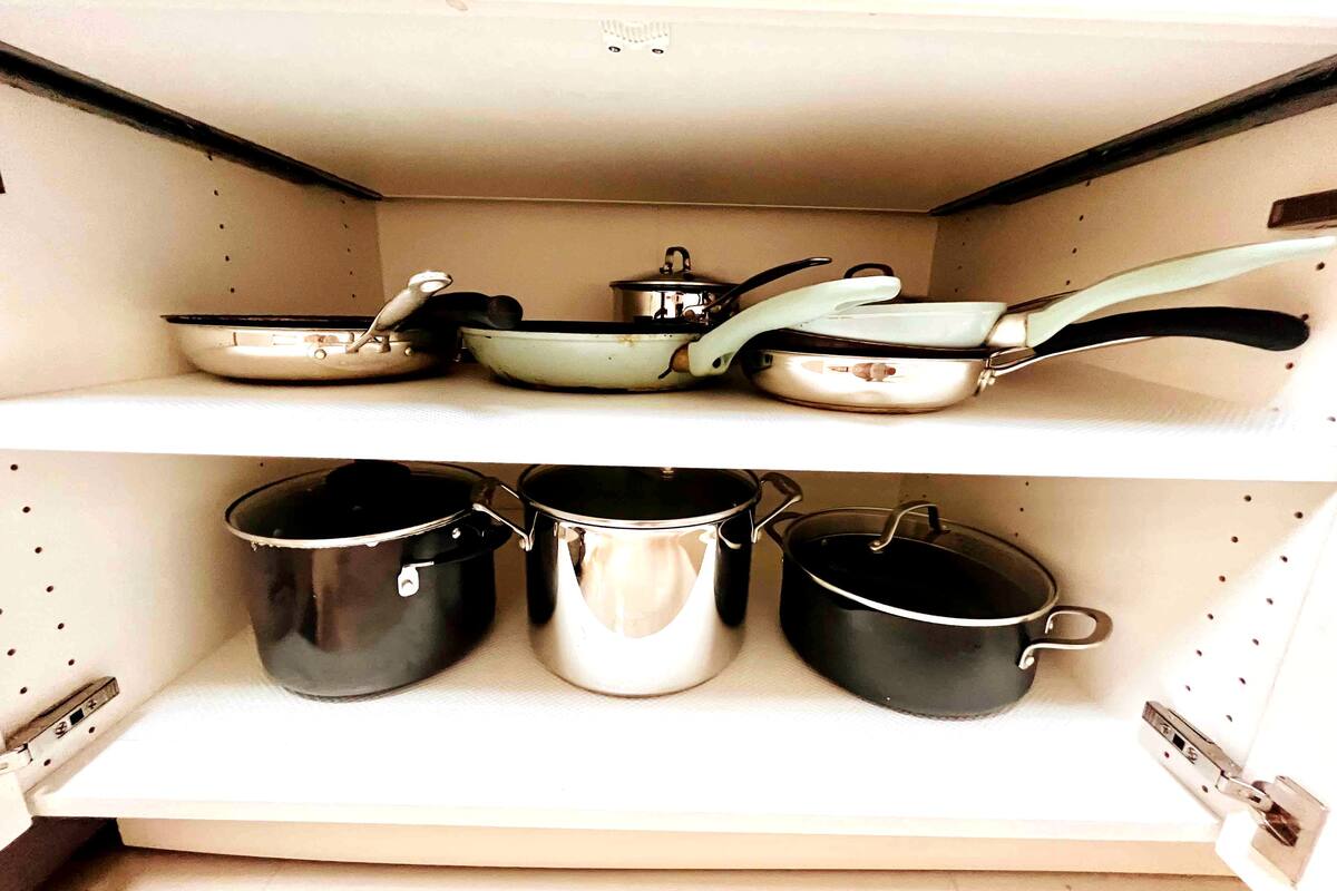 Pots and pans neatly arranged in a pull-out kitchen drawer in the one-bedroom apartment