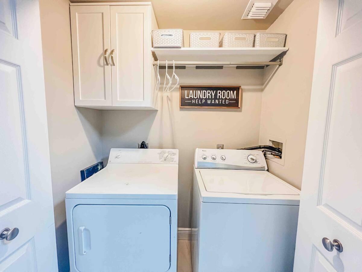 In-unit laundry closet with full-size washer and dryer in the Aventura one-bedroom rental