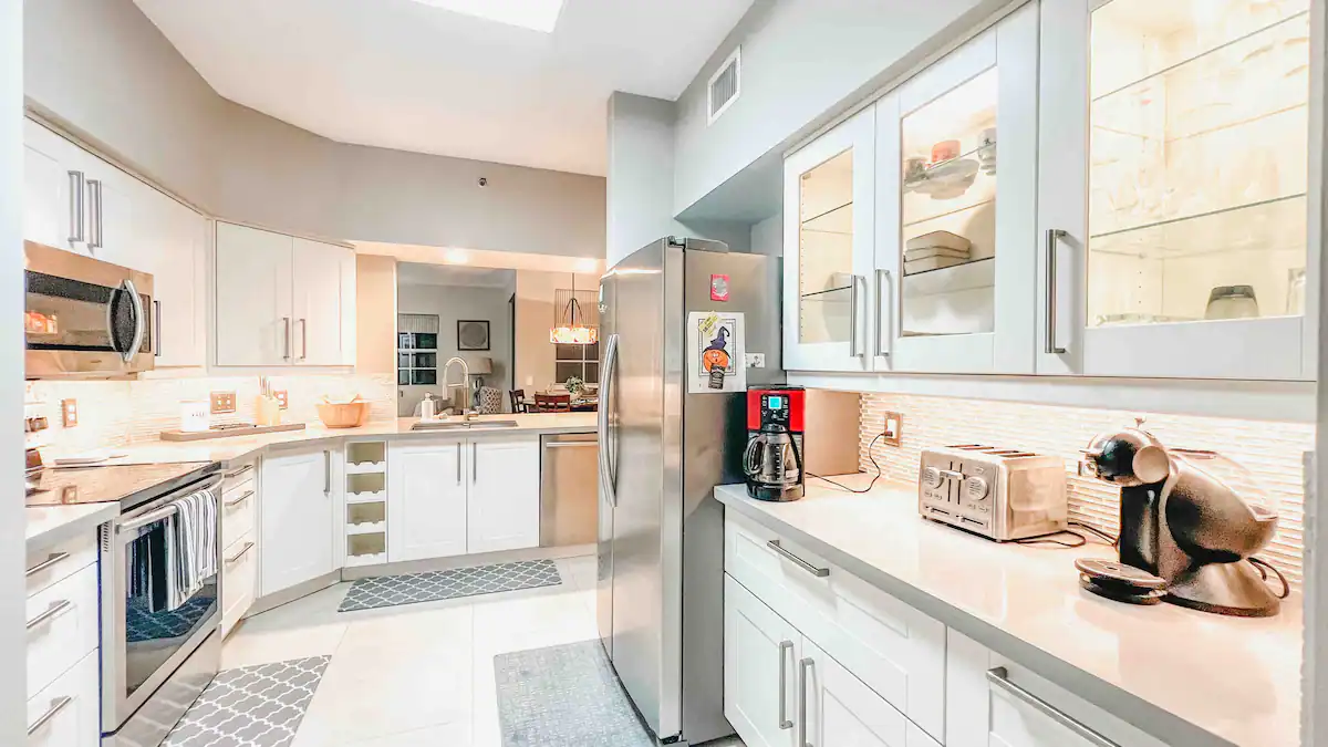 Modern kitchen with stainless-steel refrigerator, breakfast bar, and full appliance suite for extended-stay cooking